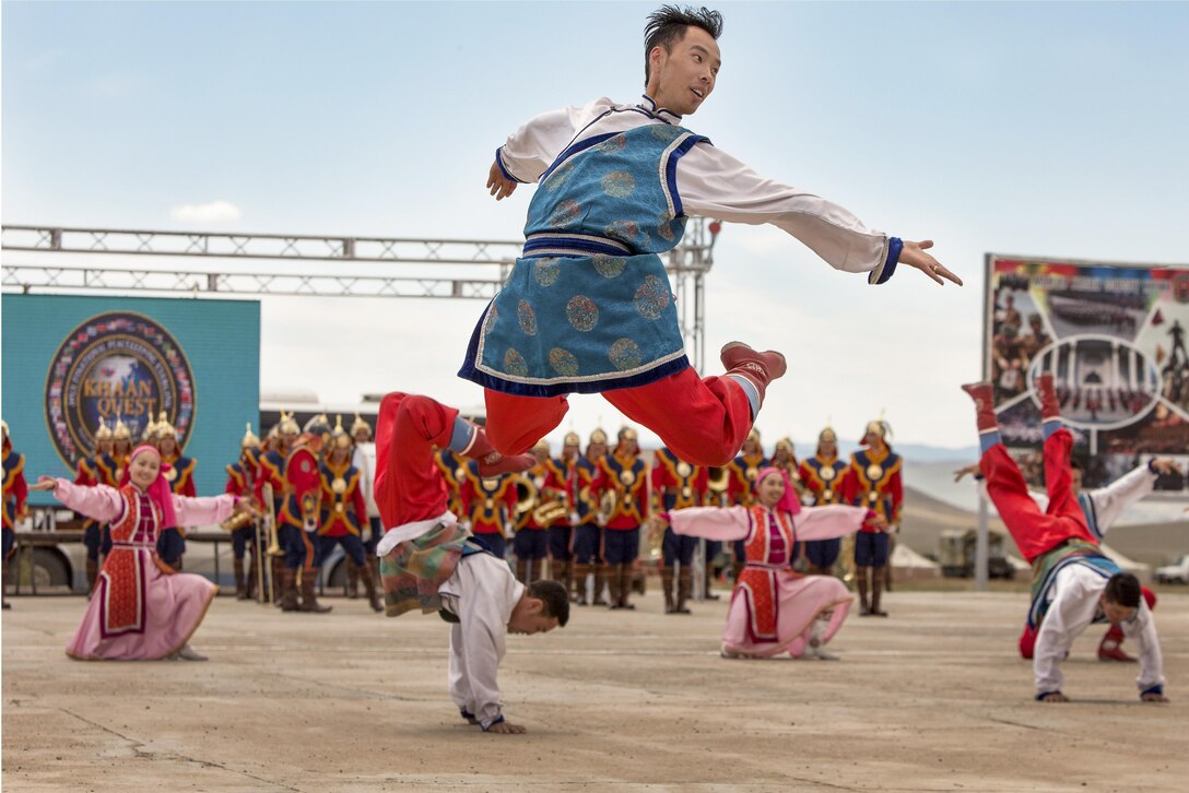 Mongolian dancers perform in traditional garb.
