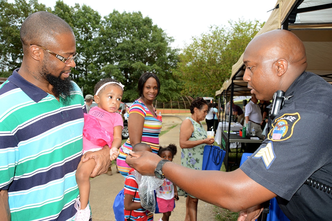 Police sergeant hands DLA police badge to young girl