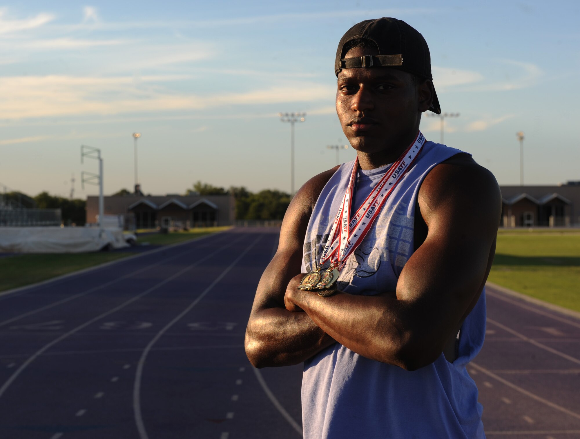 U.S. Air Force Senior Airman Parnelle Shands, 317th Aircraft Maintenance Squadron crew chief, wears medals won from previous track and field events at Abilene Christian University, Texas, July 14, 2017. Shands participated in several events with the U.S. Air Force Track and Field team such as long jump, 100-meter dash and a 4x100 relay. (U.S. Air Force photo by Airman Kylee Thomas)