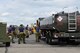 Royal Canadian Air Force (RCAF) airmen speak amongst themselves as a U.S. Air Force fuel truck pulls up to refuel a RCAF CF-18 Hornet fighter aircraft assigned to the 425th Tactical Fighter Squadron, Canadian Forces Base, Bagotville, Canada, Aug. 1, 2017, at Eielson Air Force Base, Alaska, during RED FLAG-Alaska (RF-A) 17-3. RF-A exercises are vital to maintaining peace and stability in the Indo-Asia-Pacific region. (U.S. Air Force photo by Senior Airman Cassie Whitman)