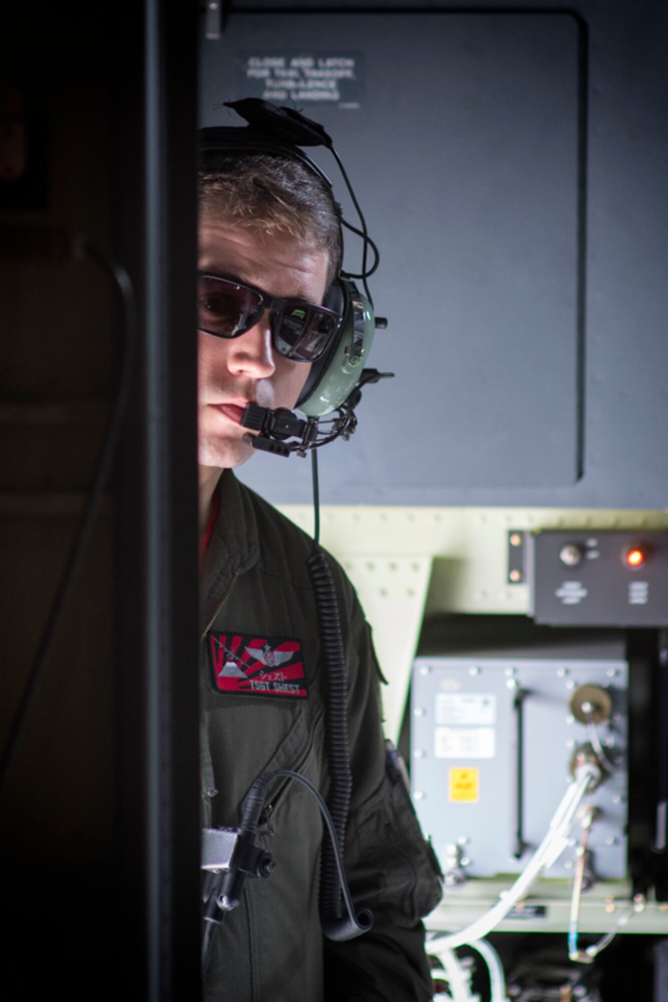 TSgt Shest communicates with crew members on a C-130J Super Hercules