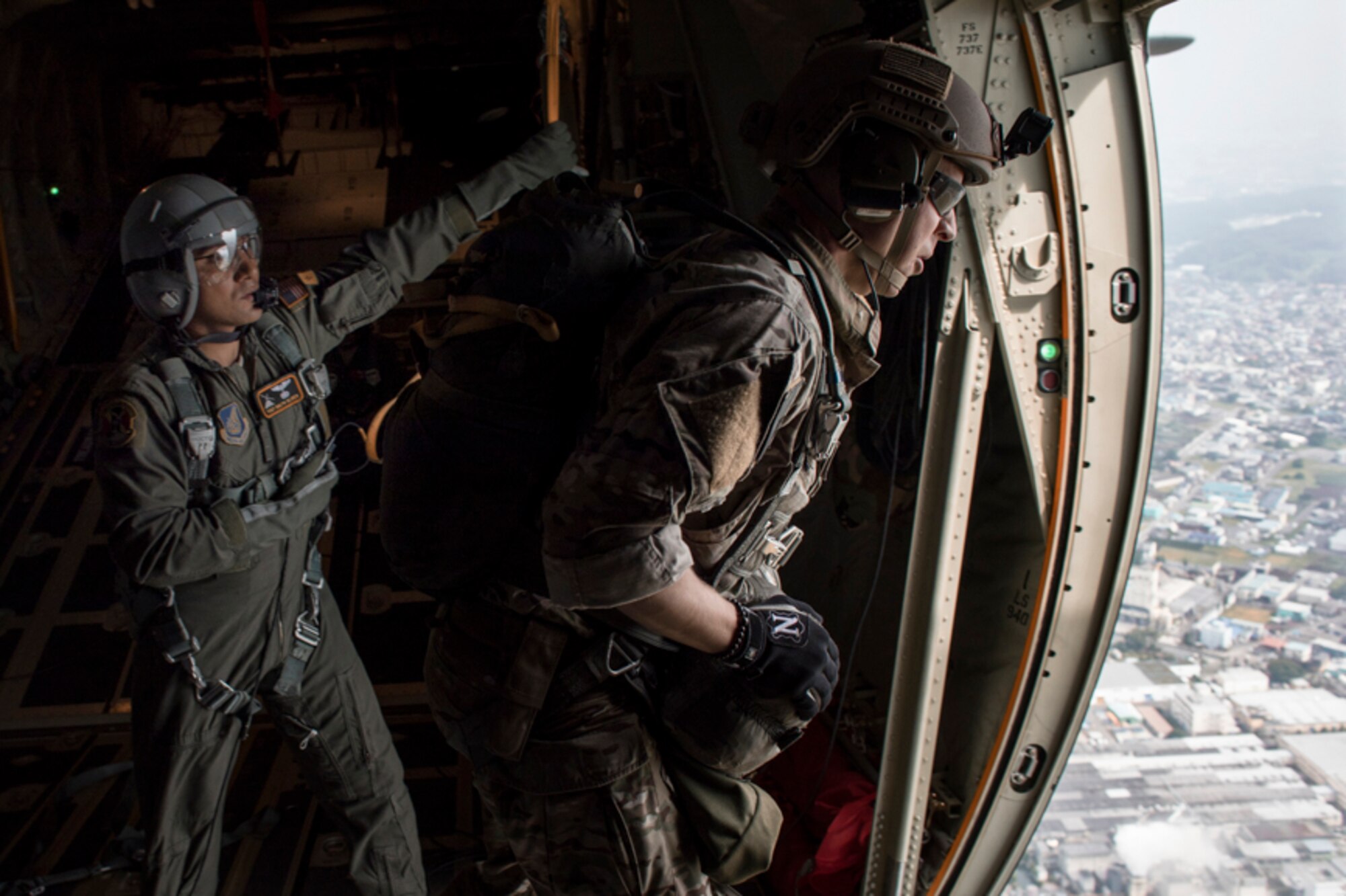 SERE specialist prepares to perform a static line jump out of a C-130J Super Hercules