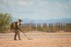 Airmen assigned to the 56th Civil Engineer Squadron explosive ordnance disposal take cover as Army UH-60 Black Hawks take off at the Florence Military Reservation in Florence Ariz., July 21, 2017. The team was dropped off by the black hawks during the initial phase of a day-long EOD training exercise. (U.S. Air Force photo/Staff Sgt. Jensen Stidham)