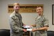 U.S. Air Force Capt. Nick Gumley, the 354th Medical Support Squadron TRICARE operations patient administration flight commander, hands Col. David Mineau, the 354th Fighter Wing commander, his Air Force Ball tickets Aug. 2, 2017, at Eielson Air Force Base, Alaska. The Air Force is celebrating its 70th Birthday and Mineau and Sheehan were one of the first to purchase their tickets. (U.S. Air Force photo by Senior Airman Cassie Whitman)
