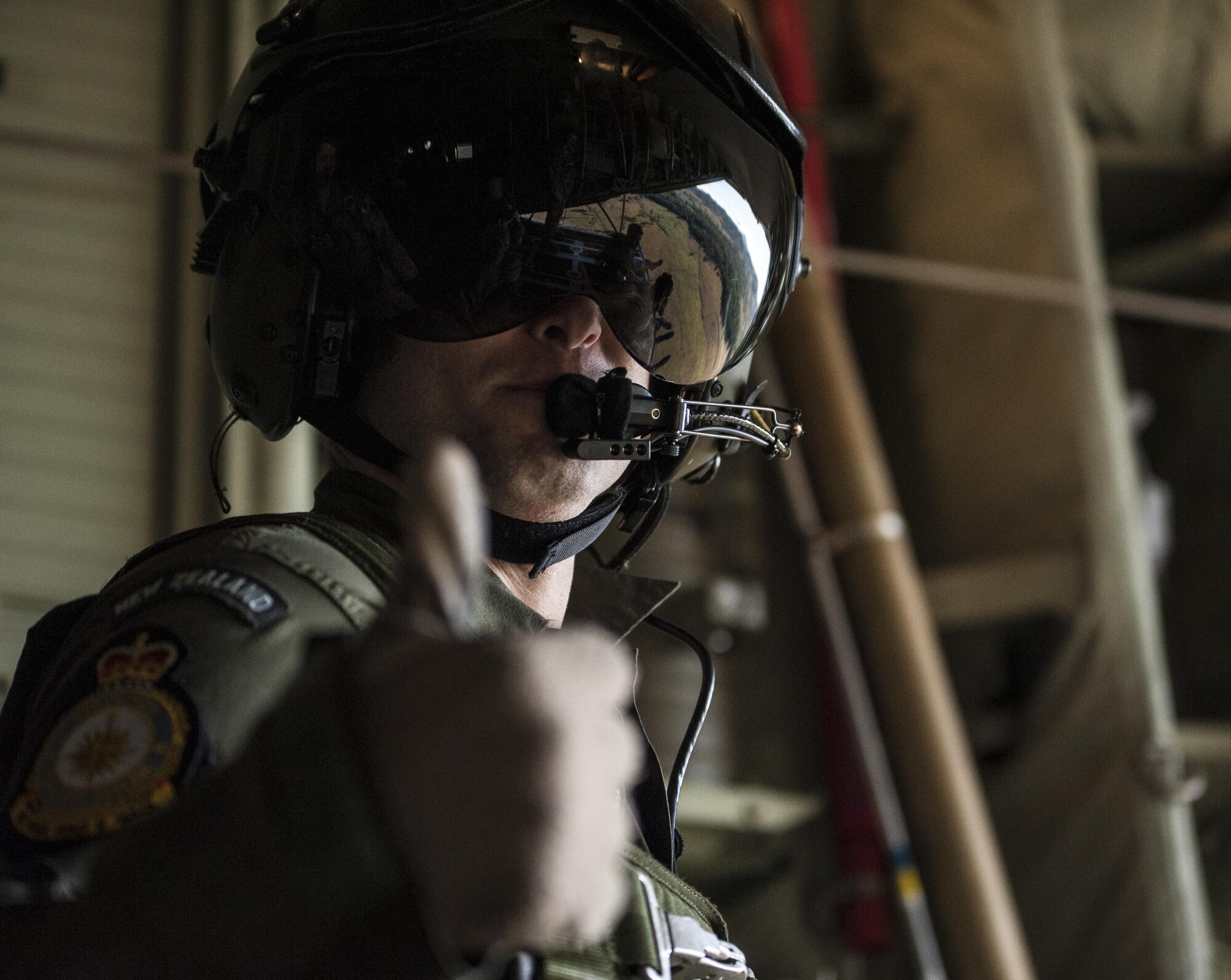 A No. 40 Squadron Royal New Zealand Air Force loadmaster looks out the back of a U.S. Air Force 17th Special Operations Squadron MC-130J Commando II during a dissimilar formation flight with a RNZAF 40 SQN C-130H(NZ) July 12, 2017, over Queensland, Australia. Talisman Saber 2017 provided the opportunity at further developing interoperability with counterparts from the RNZAF through daily airborne operations to include low-level formation work. (U.S. Air Force photo by Capt. Jessica Tait)