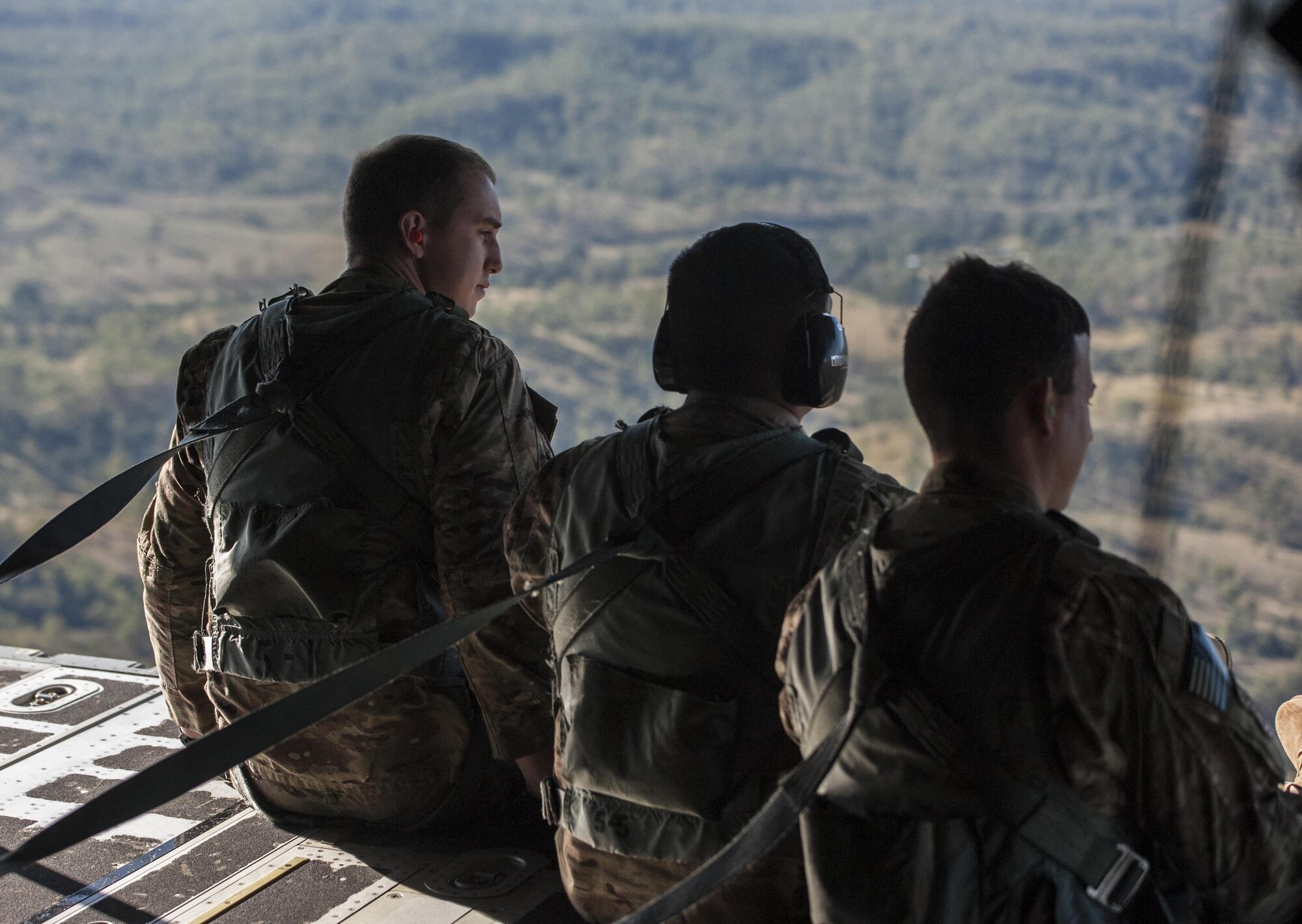 U.S. Air Force 353rd Special Operations Group members look out the back of a U.S. Air Force 17th Special Operations Squadron MC-130J Commando II during a dissimilar formation flight with No. 40 Squadron Royal New Zealand Air Force July 12, 2017, over Queensland, Australia. The bilateral training event demonstrated the strength of the alliance between the United States and New Zealand. (U.S. Air Force photo by Capt. Jessica Tait)