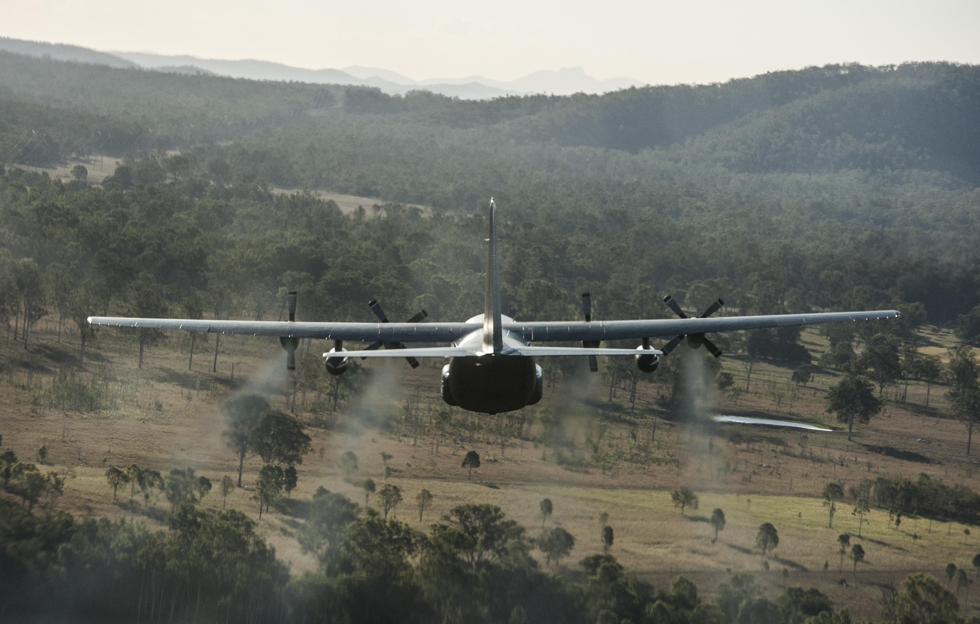 A No. 40 Squadron Royal New Zealand Air Force C-130H(NZ) flies in dissimilar formation with a U.S. Air Force 17th Special Operations Squadron MC-130J Commando II July 12, 2017 over Queensland, Australia. Executing airborne operations throughout Talisman Saber 2017, the bilateral training event symbolized the strength of a partnership that has evolved over the years. (U.S. Air Force photo by Capt. Jessica Tait)