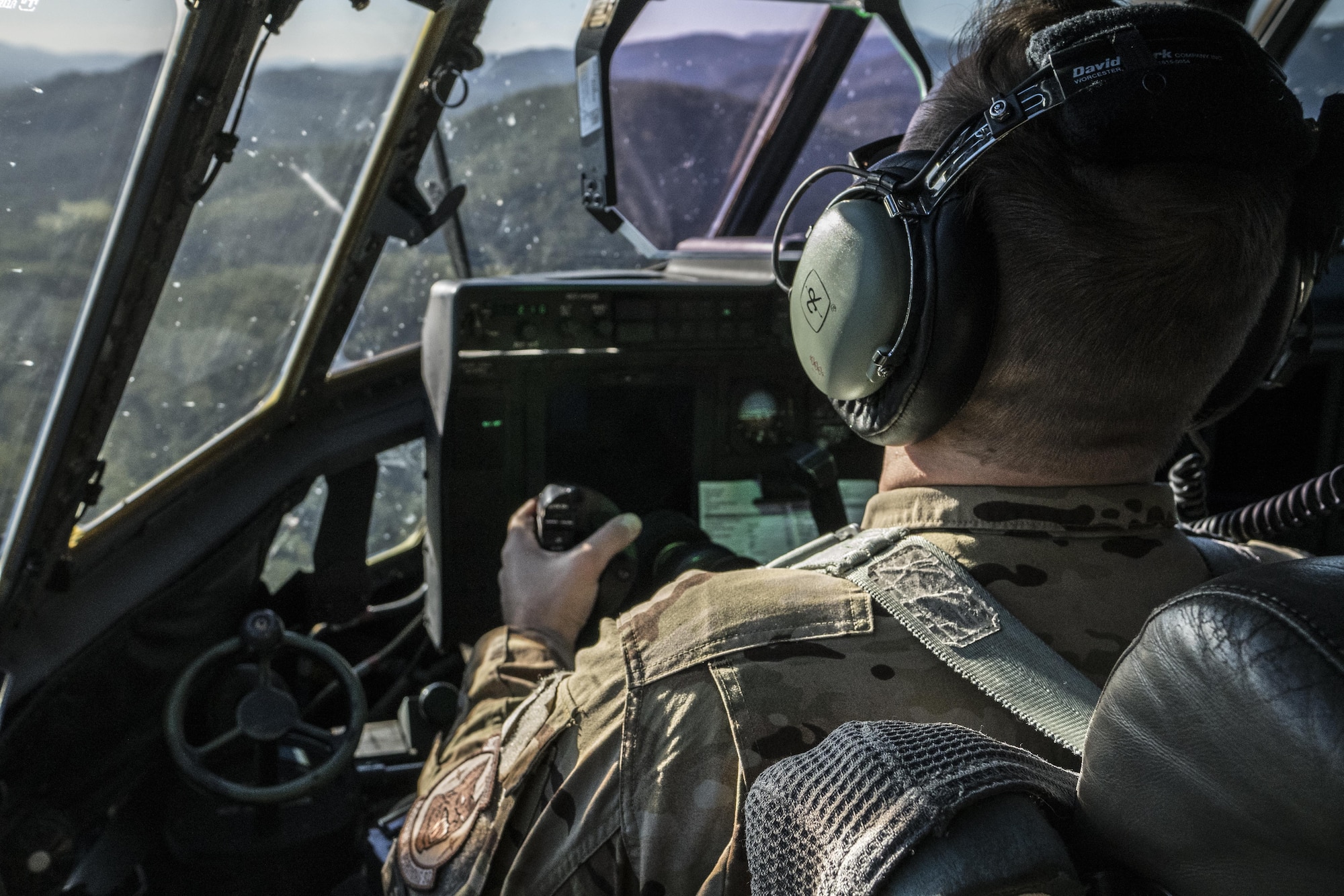 A U.S. Air Force 17th Special Operations Squadron pilot looks out the window of a U.S. Air Force MC-130J Commando II during a dissimilar formation flight with No. 40 Squadron Royal New Zealand Air Force July 12, 2017 over Queensland, Australia. Talisman Saber 2017 provided the opportunity at further developing interoperability with counterparts from the RNZAF through daily airborne operations to include low-level formation work. (U.S. Air Force photo by Capt. Jessica Tait)