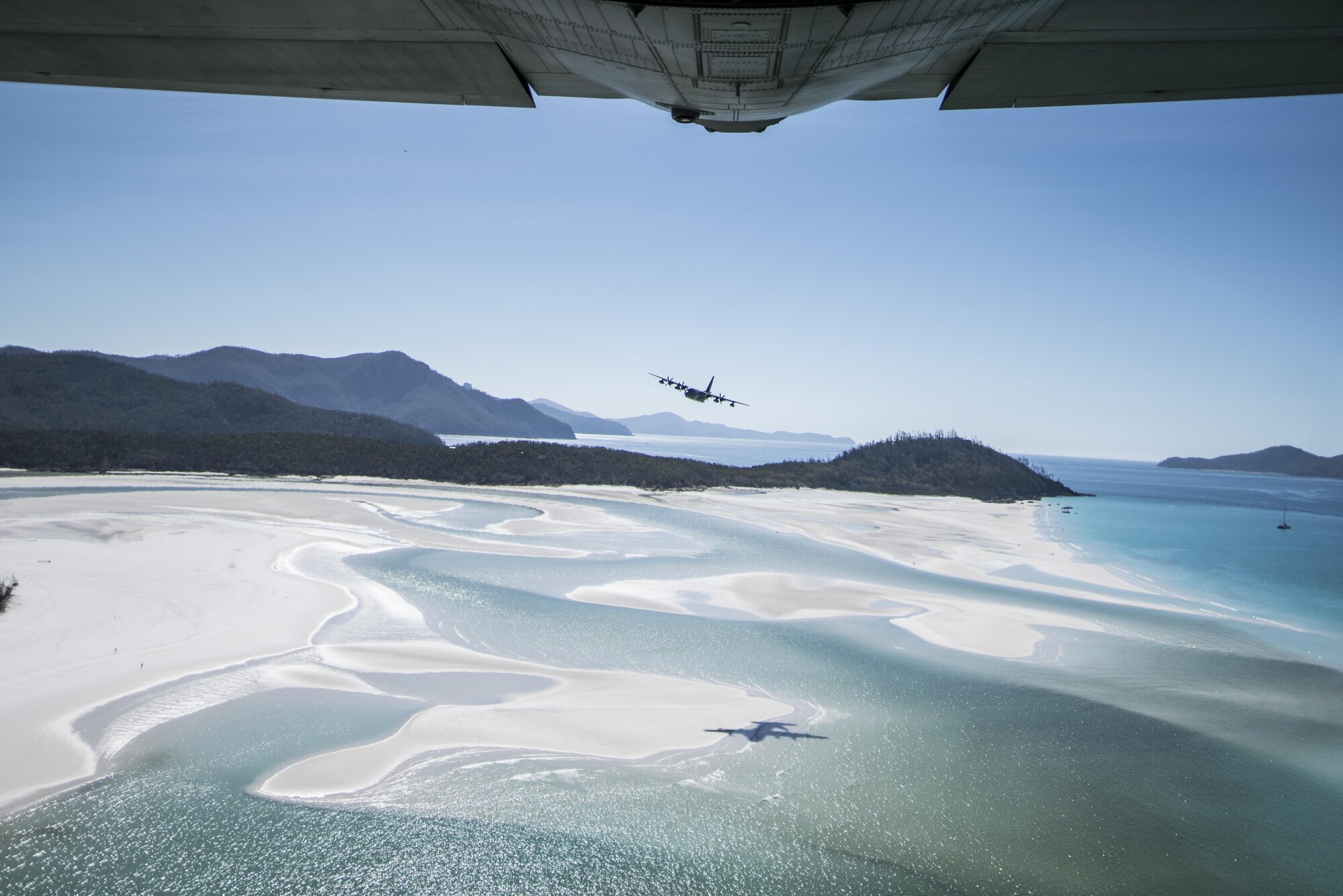 A U.S. Air Force 17th Special Operations Squadron MC-130J Commando II flies in dissimilar formation with a 37th Squadron Royal Australian Air Force C-130J Hercules July 19, 2017, over Queensland, Australia. Talisman Saber 2017 provided the opportunity at further developing interoperability with counterparts from the RAAF through daily airborne operations to include low-level formation work, forward air refueling point, and personnel and cargo airdrops. (U.S. Air Force photo by Capt. Jessica Tait)