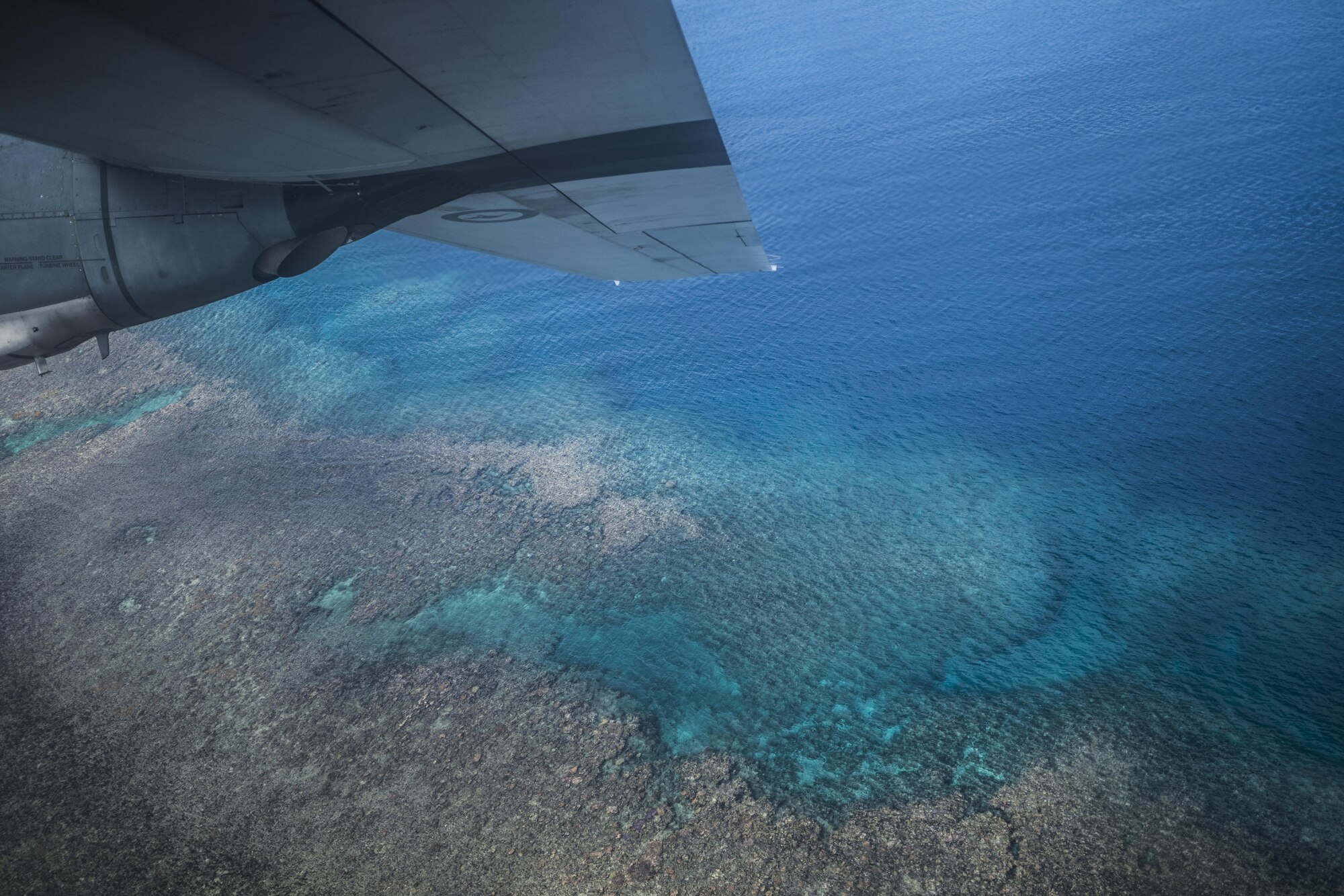 A No. 37 Squadron Royal Australian Air Force C-130J Hercules flies over the Great Barrier Reef during a bilateral interfly with a U.S. Air Force 17th Special Operations Squadron MC-130J Commando II July 19, 2017, over Queensland, Australia. Executing airborne operations throughout Talisman Saber 2017, the dissimilar formation flight symbolized the strength of a partnership that has evolved over the years. (U.S. Air Force photo by Capt. Jessica Tait)