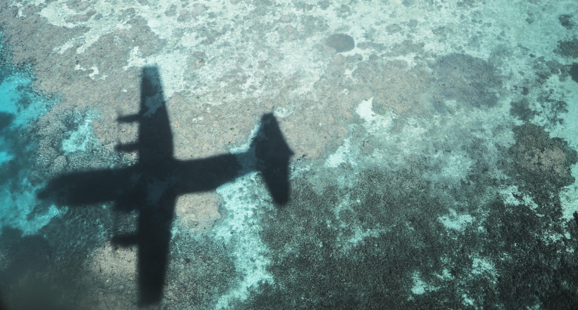 A No. 37 Squadron Royal Australian Air Force C-130J Hercules flies over the Great Barrier Reef during a bilateral interfly with a U.S. Air Force 17th Special Operations Squadron MC-130J Commando II July 19, 2017, over Queensland, Australia. The bilateral training events performed during Talisman Saber 2017 enable greater interoperability between the U.S. and Australian militaries. (U.S. Air Force photo by Capt. Jessica Tait)