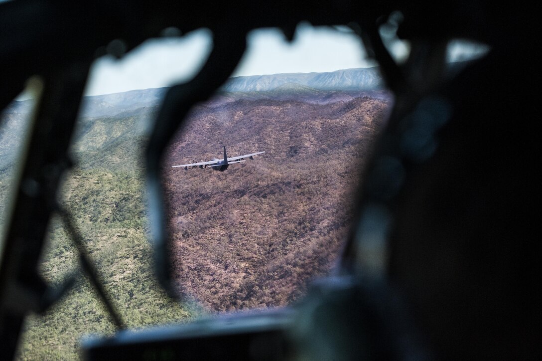 A U.S. Air Force 17th Special Operations Squadron MC-130J Commando II flies in dissimilar formation with a No. 37 Squadron Royal Australian Air Force C-130J Hercules July 19, 2017, over Queensland, Australia. Talisman Saber 2017 provided the opportunity at further developing interoperability with counterparts from the RAAF through daily airborne operations to include low-level formation work, forward air refueling point, and personnel and cargo airdrops. (U.S. Air Force photo by Capt. Jessica Tait)
