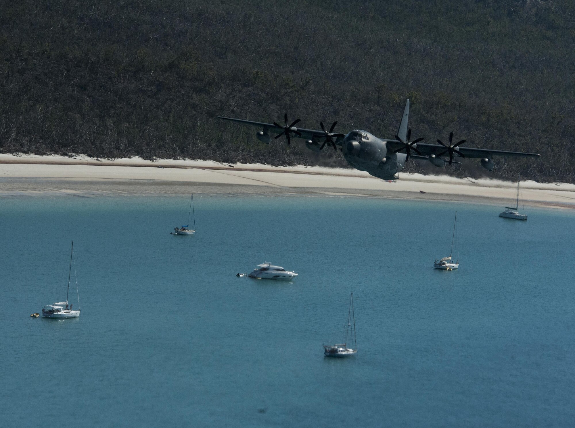 A U.S. Air Force 17th Special Operations Squadron MC-130J Commando II flies in dissimilar formation with a No. 37 Squadron Royal Australian Air Force C-130J Hercules July 19, 2017, over Queensland, Australia. The development of dissimilar formation tactics, training and procedures enables greater interoperability between the U.S. and Australian militaries. (U.S. Air Force photo by Capt. Jessica Tait)