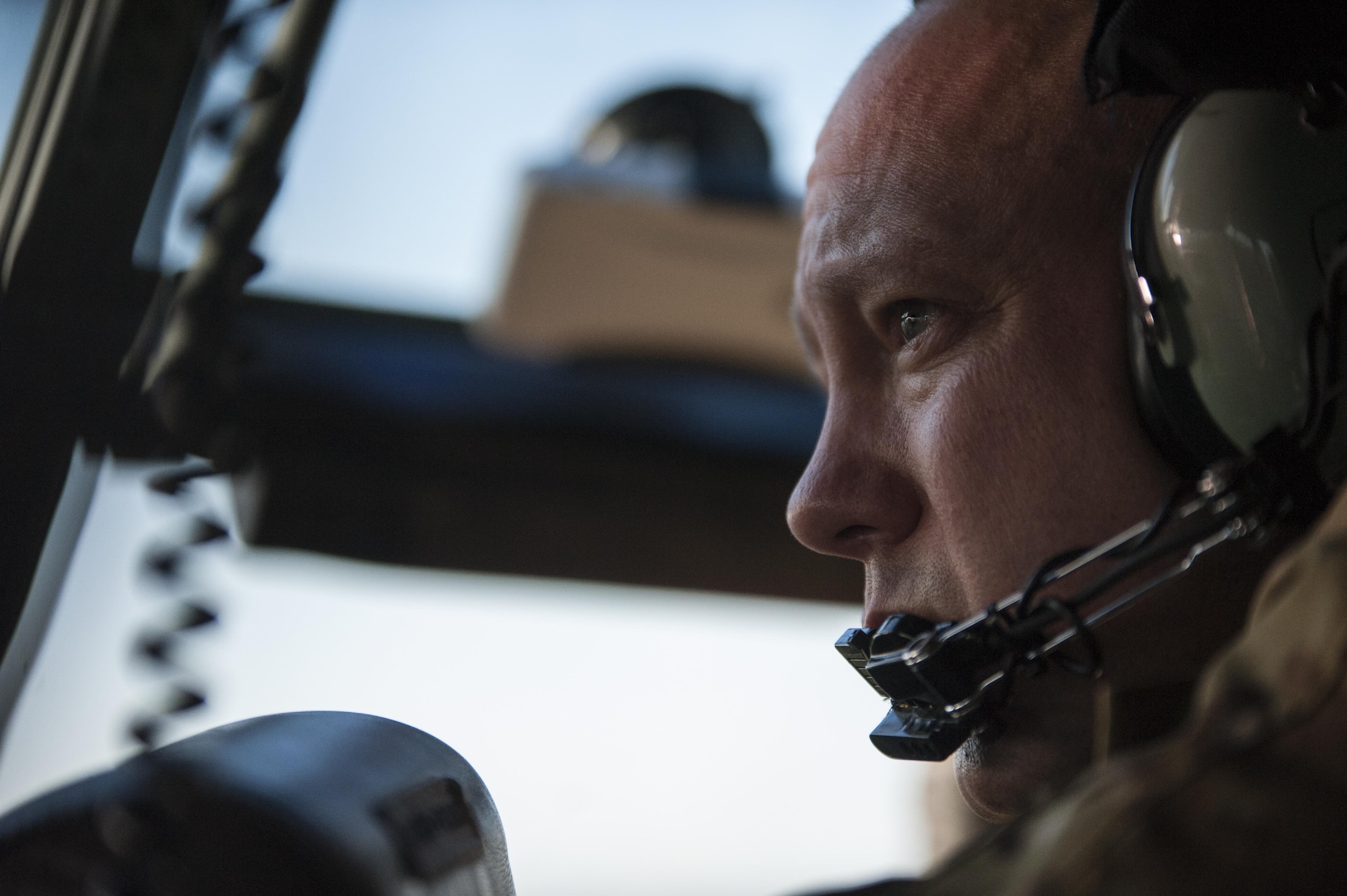 A U.S. Air Force 17th Special Operations Squadron combat systems officer watches the No. 40 Squadron Royal New Zealand Air Force C-130H take the lead during a dissimilar formation flight July 12, 2017 over Queensland, Australia. Talisman Saber 2017 provided the opportunity at further developing interoperability with counterparts from the RNZAF through daily airborne operations to include low-level formation work. (U.S. Air Force photo by Capt. Jessica Tait)