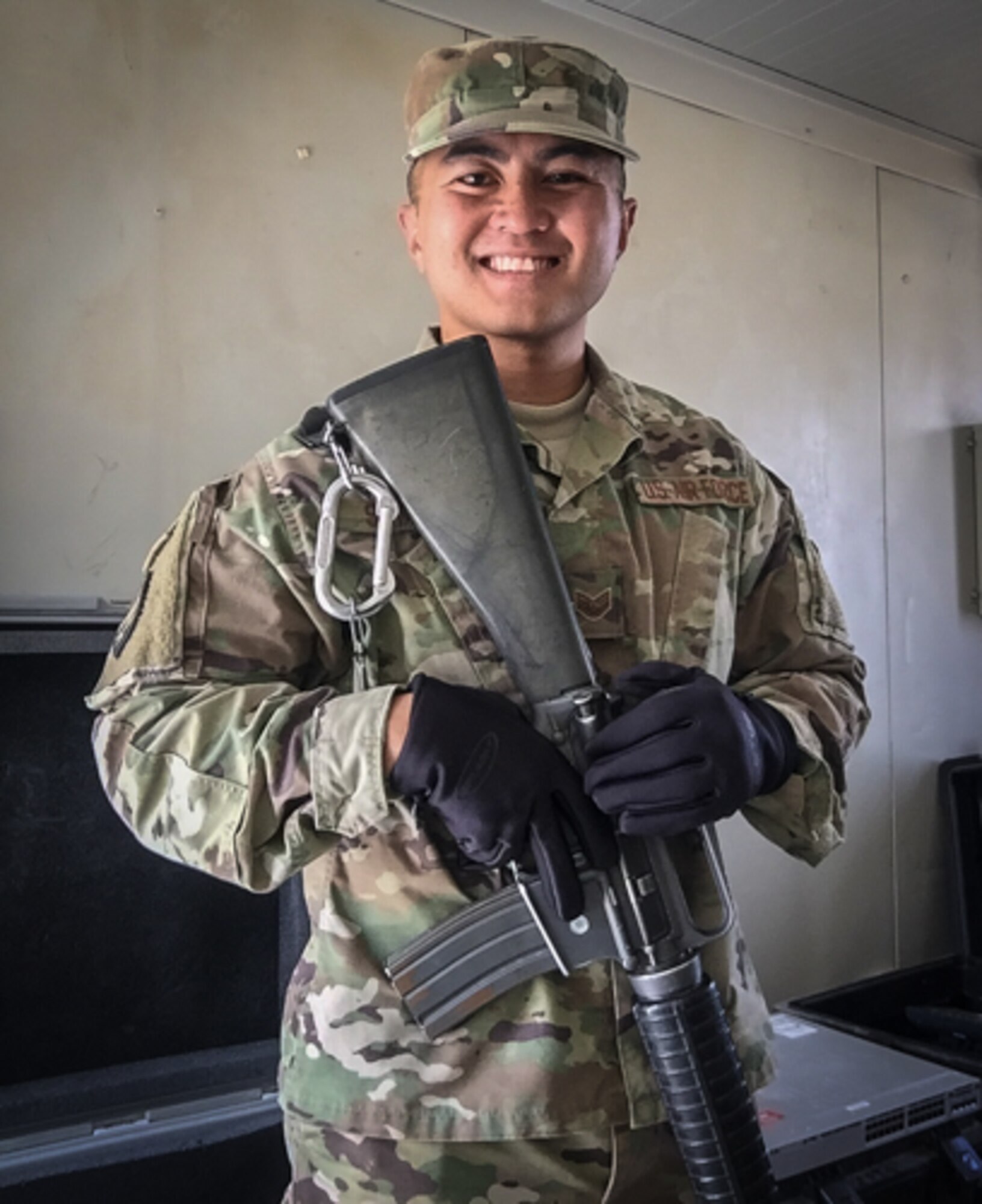 U.S. Air Force Staff Sgt. Junbryan Samson, a cyber network technician assigned to the U.S. Air Forces Central Command communications division at the Combined Air Operations Center smiles for a photo July 24, 2017, at Al Asad Air Base, Iraq. Samson traveled to Iraq to set up 40 network stations in support Air Force units forward deployed in the fight against ISIS. (Courtesy photo by Staff Sgt. Junbryan Samson