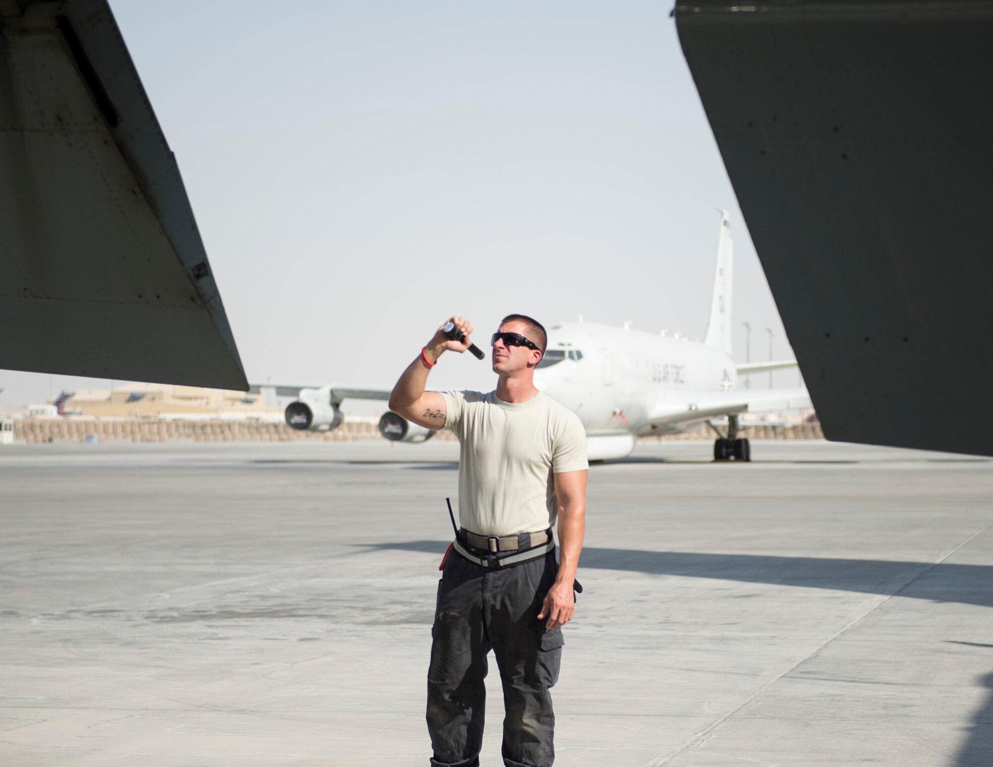 U.S Air Force Staff Sgt. Aaron Hasenauer, crew chief with the 763rd Expeditionary Aircraft Maintenance Unit, conducts a post-flight inspection on a RC-135V/W Rivet Joint at Al Udeid Air Base, Qatar, July 27, 2017.
