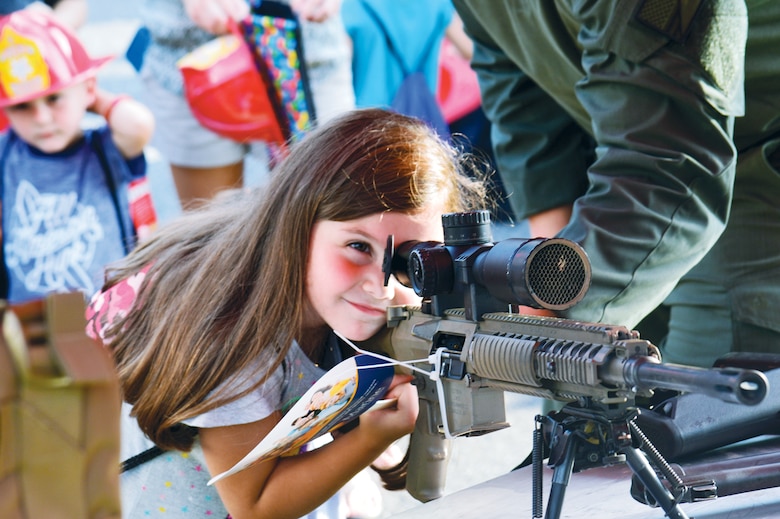 A child scopes out the land at the National Night Out after the Provost Marshal's Office brought some of their tactical gear for members of the community to learn about.