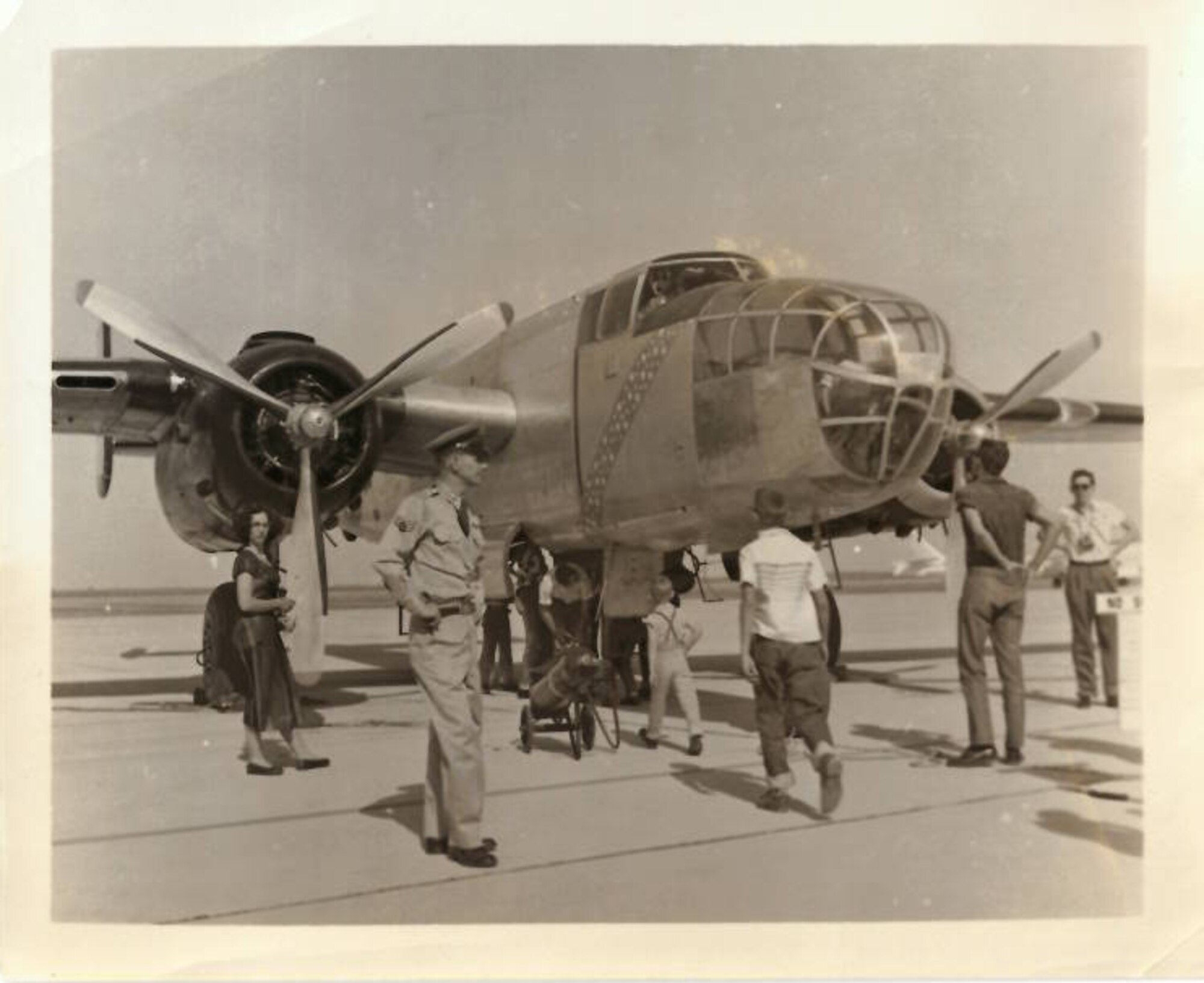 Russel Sharp, prior Air Force crew-chief and flight engineer for the B-25 aircraft, stands near his B-25.