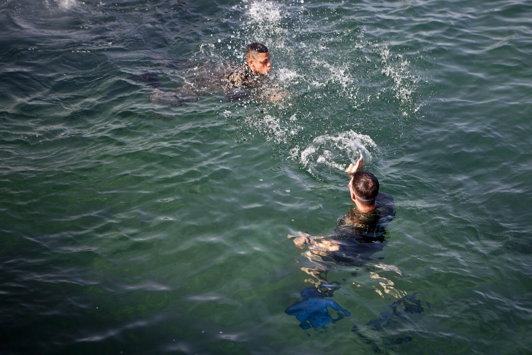 U.S. Marine Sgt. David G. Gaudette II, the detachment staff noncommissioned officer in charge of the Honduras Detachment, Ground Combat Element, Special Purpose Marine Air-Ground Task Force - Southern Command, trains Honduran marines in basic water survival skills in Trujillo, Honduras, July 26, 2017. The training was part of a basic infantry skills course for Honduran marines. The Marines and sailors of SPMAGTF-SC are deployed to Central America from June to November 2017 to conduct security cooperation training and engineering projects with their counterparts in Belize, El Salvador, Guatemala, and Honduras.