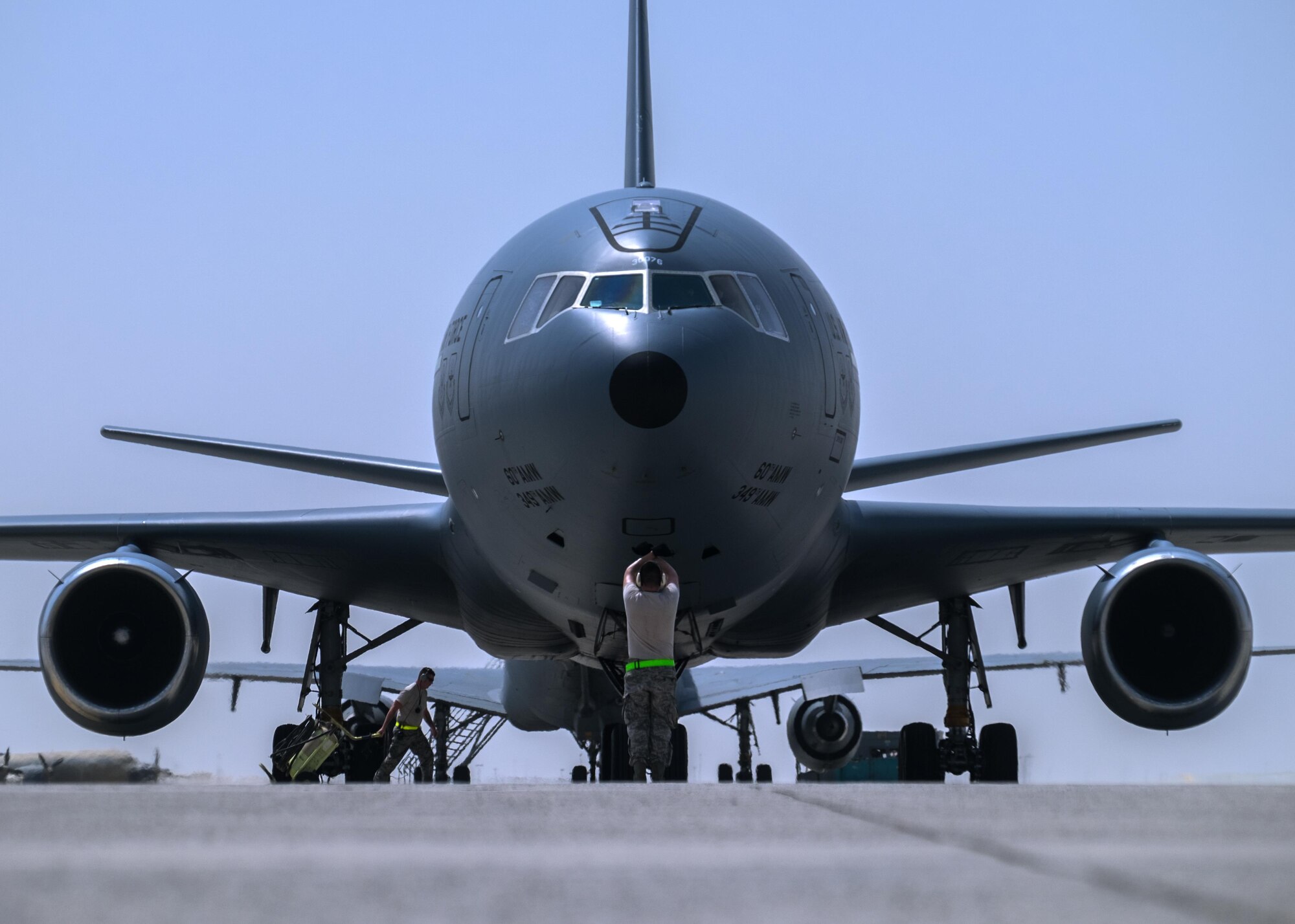Tech. Sgt. Javier, 380th Aircraft Maintenance Squadron Extender Aircraft Maintenance Unit crew chief, marshals a KC-10 Extender August 3, 2017, at Al Dhafra Air Base, United Arab Emirates.
