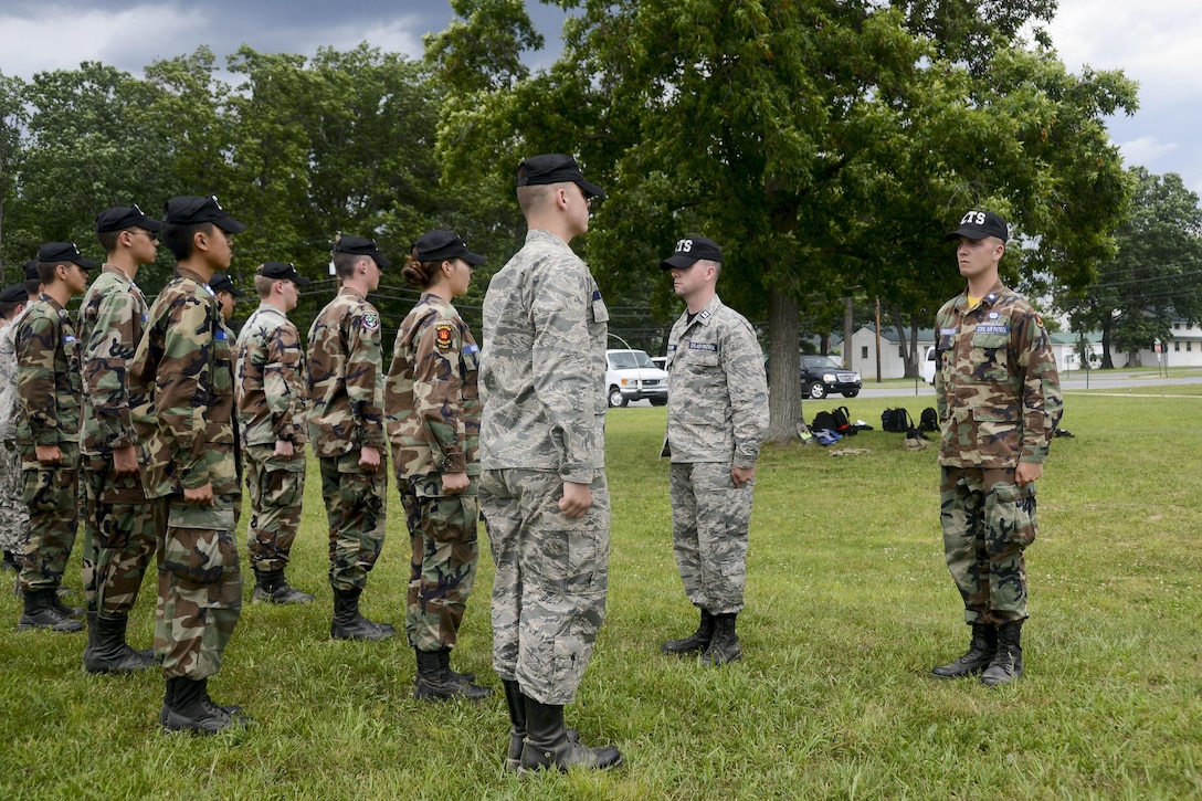 Airmen inspect a cadet formation.