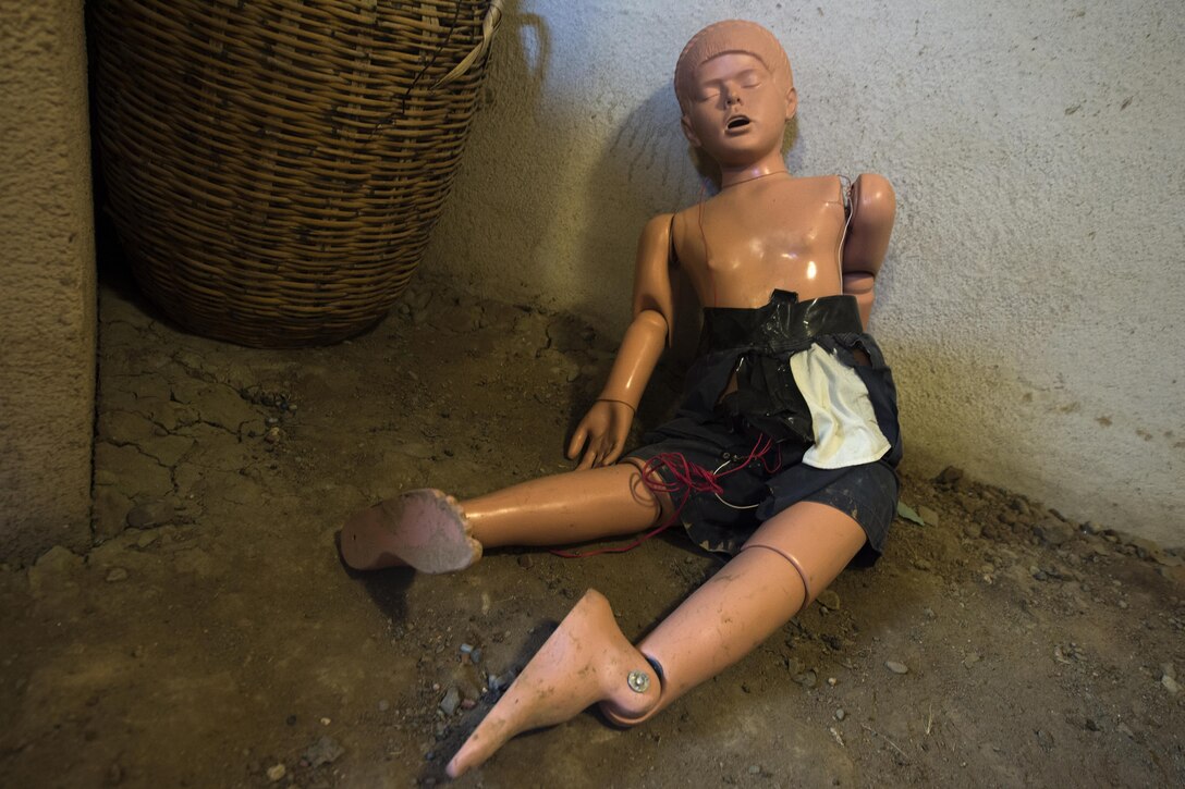 A mannequin with a bomb vest lies on the floor.