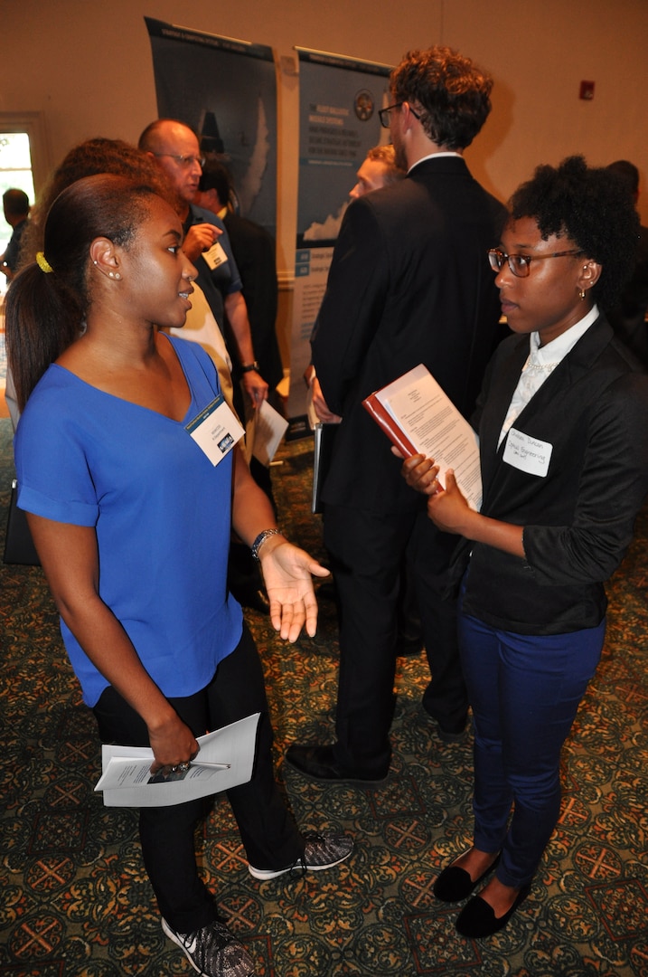Image: Taylor Evans, an employee of the Readiness and Training Systems Department at the Naval Surface Warfare Center Dahlgren Division (NSWCDD), discusses career opportunities with a candidate at an NSWCDD job fair. The command's Human Resources Division announced Aug. 2 that it plans to make about 100 tentative job offers to candidates who attended the event. Approximately 325 candidates with bachelor's, master's, and doctoral degrees in biology, chemistry, computer science, engineering, mathematics, and physics spoke with senior Navy scientists, engineers, and managers about positions available for entry-level and experienced scientists and engineers.