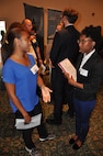 Image: Taylor Evans, an employee of the Readiness and Training Systems Department at the Naval Surface Warfare Center Dahlgren Division (NSWCDD), discusses career opportunities with a candidate at an NSWCDD job fair. The command's Human Resources Division announced Aug. 2 that it plans to make about 100 tentative job offers to candidates who attended the event. Approximately 325 candidates with bachelor's, master's, and doctoral degrees in biology, chemistry, computer science, engineering, mathematics, and physics spoke with senior Navy scientists, engineers, and managers about positions available for entry-level and experienced scientists and engineers.
