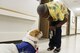 Caren Peagler, 88th Medical Center referral management administration technician, gets a visit from pet therapy dog Bailey from the Miami Valley Pet Therapy Association on July 21, 2017. Pet therapy dogs visits patients and staff members at the medical center seven days a week. (U.S. Air Force photo/Stacey Geiger)