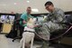 Capt. Robert Baldwin and 1st Lt. Gregory Caliwag, 88th Medical Center clinical nurses pet Bailey, a pet therapy dog from the Miami Valley Pet Therapy Association on July 21, 2017. Pet therapy dogs visit the medical center seven days a week to provide comfort to patients and staff members.  (U.S. Air Force photo/Stacey Geiger)