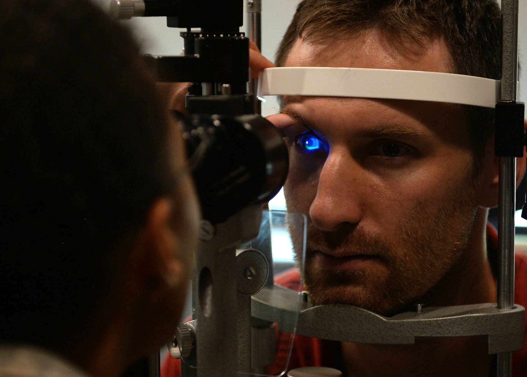 Capt. Brennan Schilperoort, 41st Airlift Squadron pilot, has his eye inspected by Maj. Felicia Rinken, 19th Medical Group optometrist, July 24, 2017 at the 19th Medical Group optometry clinic on Little Rock Air Force Base, Arkansas. The optometry clinic ensures Airmen at Little Rock Air Force base are visually fit to fight by providing annual eye exams, pre-operation and post operation eye care, and diagnosing and treating eye infections. (U.S. Air Force photo by Airman 1st Class Codie Collins)
