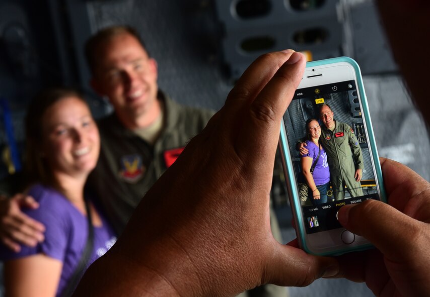 Maj. Richard, 432nd Wing MQ-1 Predator pilot, takes a photo with his cousin July 15, 2017, at the Lethbridge International Airshow in Alberta, Canada. Richard grew up near Lethbridge for 15 years and hasn't seen his cousin since he moved to the United States. (U.S. Air Force photo/Senior Airman Christian Clausen)