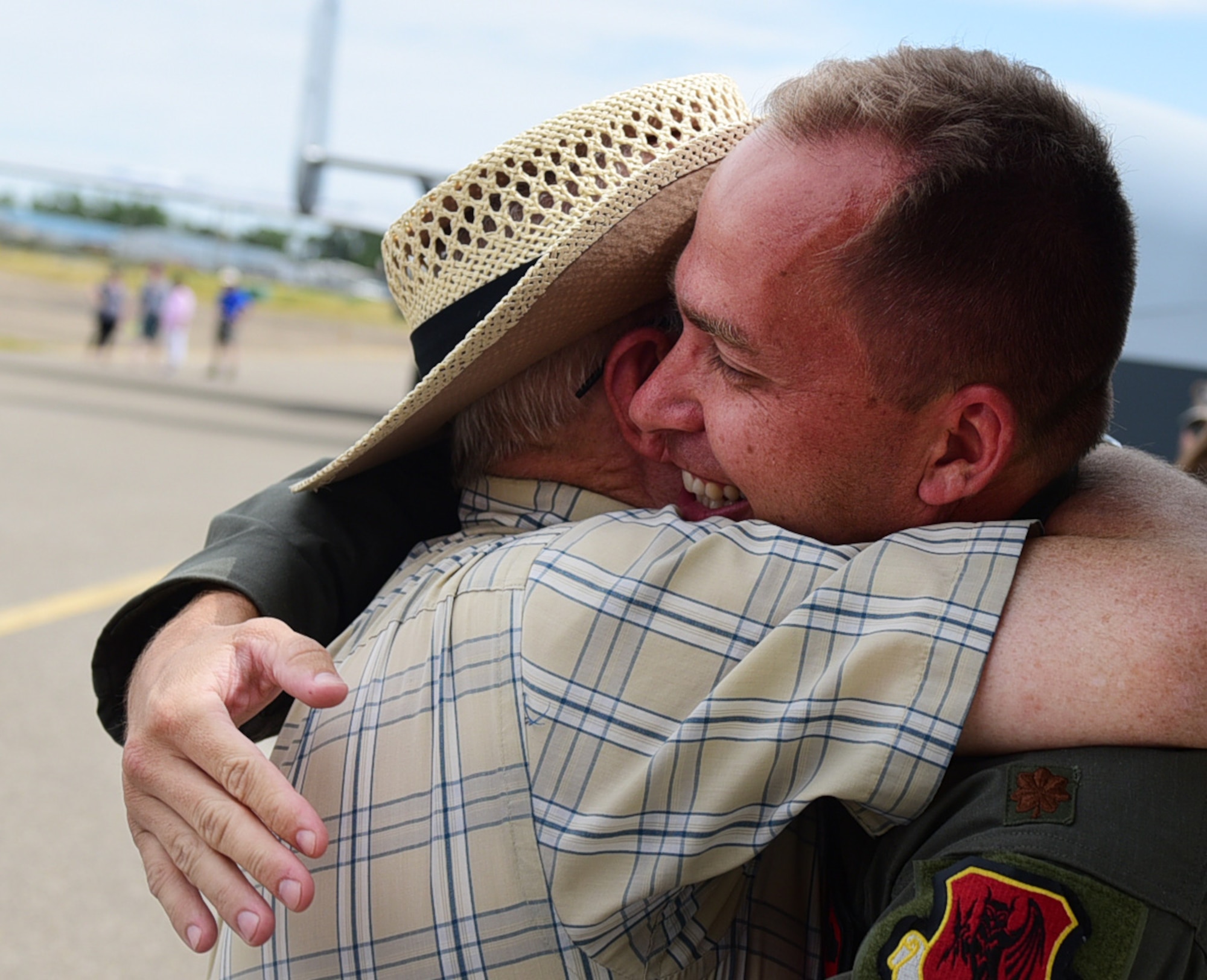 Maj. Richard, 432nd Wing MQ-1 Predator pilot, hugs his uncle July 15, 2017, at the Lethbridge International Airshow in Alberta, Canada. Richard had the opportunity to visit family and friends while displaying the MQ-9 Reaper at the airshow where he first fell in love with aviation. (U.S. Air Force photo/Senior Airman Christian Clausen)