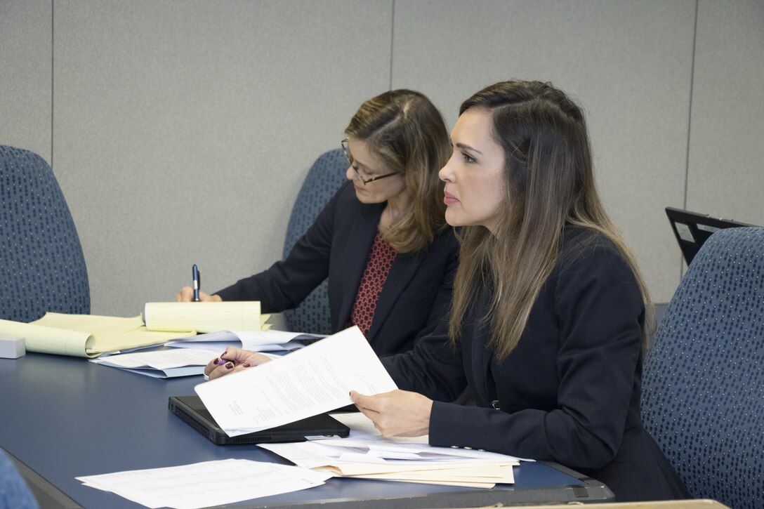 Attorneys listen during contract litigation workshop.