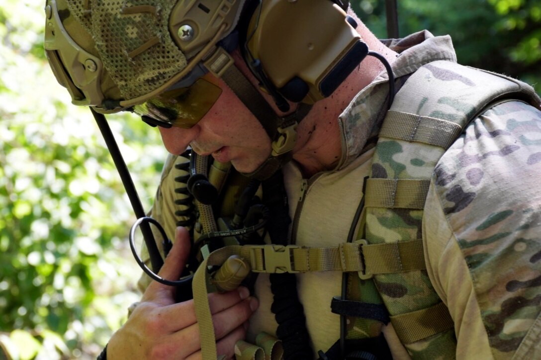 A Joint Terminal Attack Controller communicates via radio as his team executes combat air controls