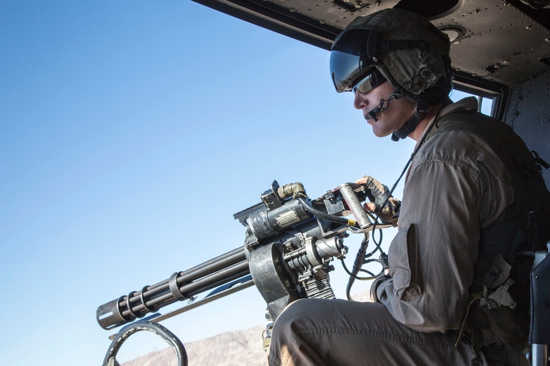 U.S. Marine Corps Staff Sgt. Dustin S. Miller, Crew Chief with Marine Light Attack Helicopter Squadron 167, Marine Air Ground Task Force 8 (MAGTF) searches for a potential target from a UH-1Y Huey Helicopter while conducting a close air support drill during Integrated Training Exercise (ITX) 5-17 at Marine Corps Air Ground Combat Center, Twentynine Palms, Calif., July 21, 2017. The purpose of ITX is to create a challenging, realistic training environment that produces combat-ready forces capable of operating as an integrated MAGTF. (U.S. Marine Corps Photo by Sgt. Kassie L. McDole)