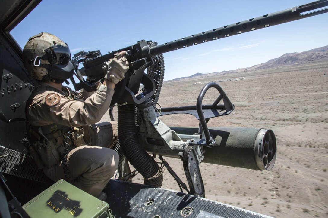 U.S. Marine Corps Staff Sgt. Ryan D. Peek, an aerial observer, with Marine Light Attack Helicopter Squadron 167, Marine Air Ground Task Force 8 (MAGTF) searches for a potential target area from a UH-1Y Huey Helicopter while conducting a close air support drill during Integrated Training Exercise (ITX) 5-17 at Marine Corps Air Ground Combat Center, Twentynine Palms, Calif., July 21, 2017. The purpose of ITX is to create a challenging, realistic training environment that produces combat-ready forces capable of operating as an integrated MAGTF. (U.S. Marine Corps Photo by Sgt. Kassie L. McDole)