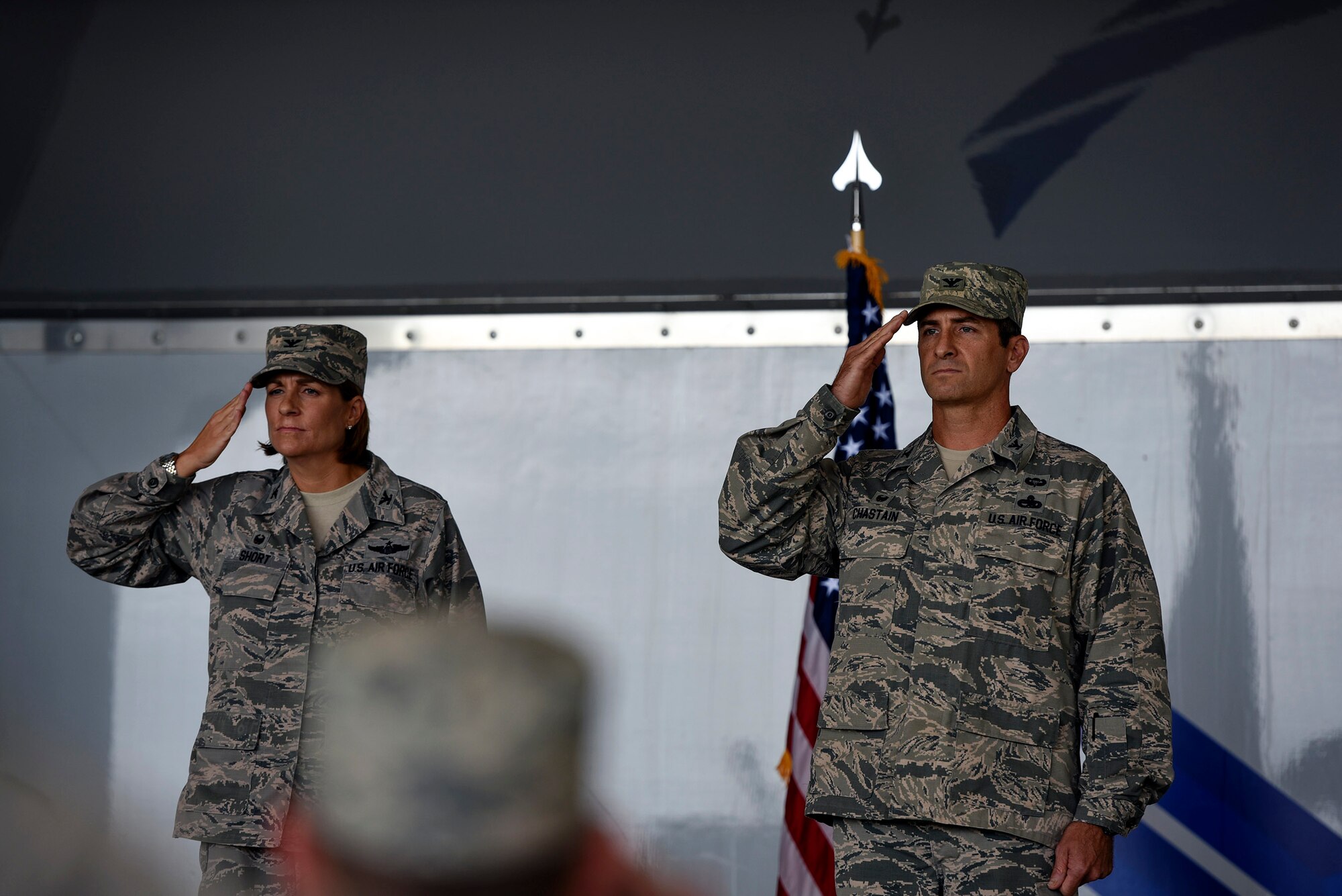 Col. Jennifer Short, 23d Wing commander, left, and incoming 23d Maintenance Group commander, Col. John Chastain, render salutes during the 23d MXG assumption of command ceremony, Aug. 3, 2017, at Moody Air Force Base, Ga.  An assumption of command is a military tradition that represents a formal assumption of a unit’s authority and responsibility by a commander. (U.S. Air Force photo by Senior Airman Greg Nash)