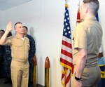 Ensign Charles Wilton (left) recites the officer oath given by Lt. David Tarasi during a commissioning ceremony at Navy Medicine Education, Training and Logistics Command, or NMETLC, headquarters at Joint Base San Antonio-Fort Sam Houston Aug. 1. Wilton was a hospital corpsman for 13 years before being selected to serve in the Chaplain Corps and receiving his commission.