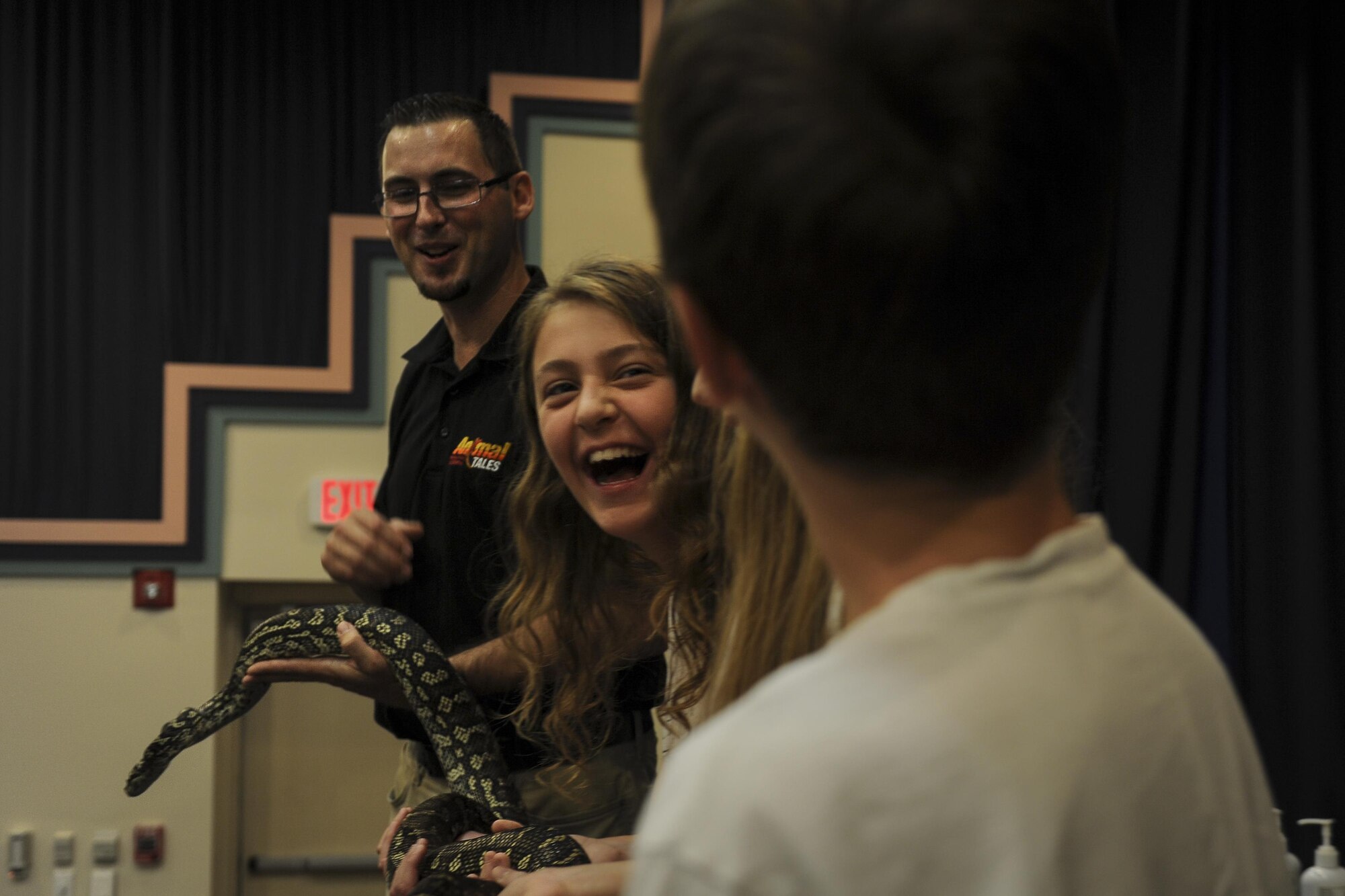 A few individuals holding a python.