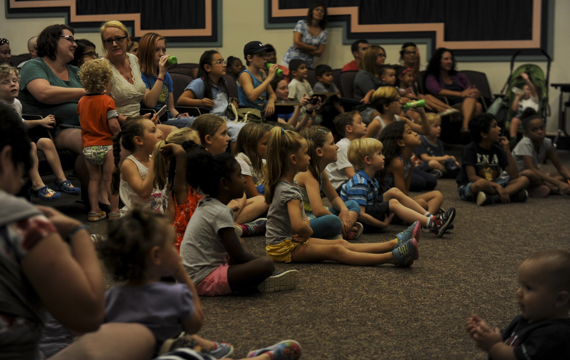 Group of kids sitting on the floor.