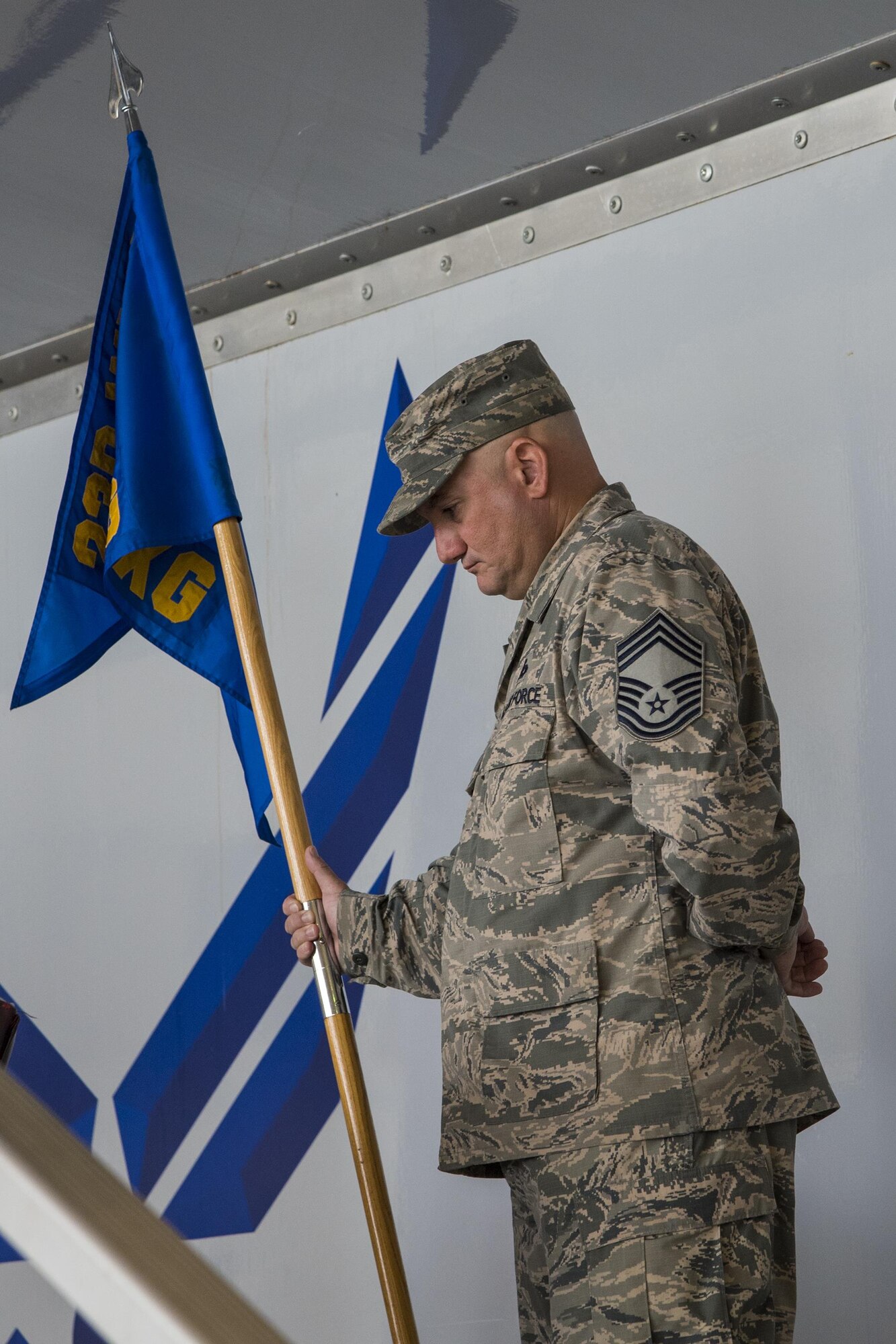 Chief Master Sgt. Bryan Preyna, Superintendent of the 23d Maintenance Group, holds the 23d Maintenance Group guidon during an assumption of command ceremony, Aug. 3,2017, at Moody Air Force Base, Ga. An assumption of command is a military tradition that represents a formal assumption of a unit’s authority and responsibility by a commander. (U.S. Air Force photo by Airman Eugene Oliver)