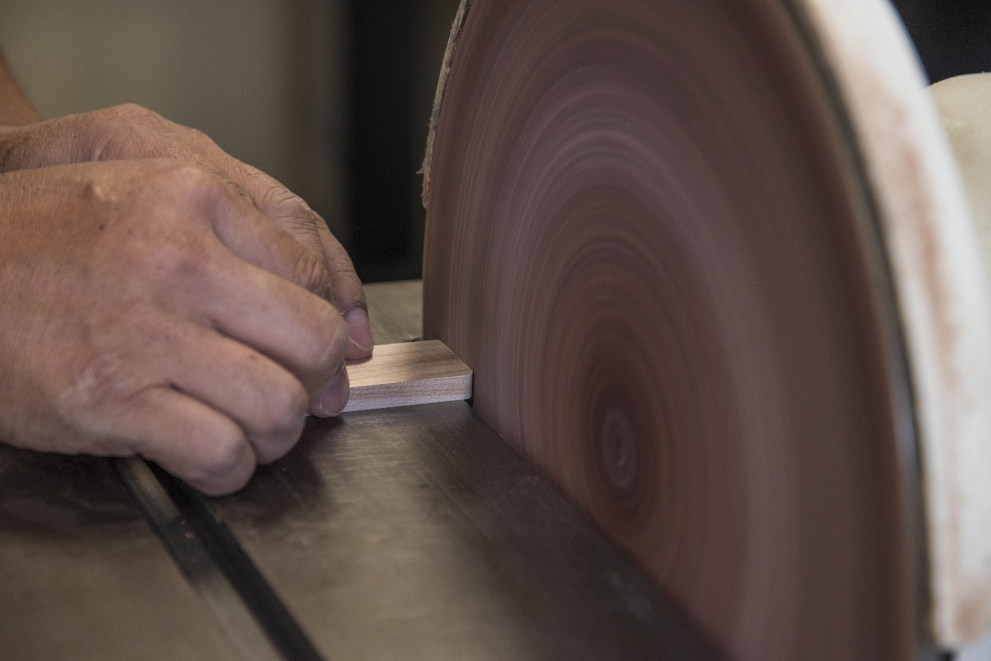 Yutaka Kashiwazaki, a 35th Force Support Squadron woodshop master laborer, uses a circular sander to smooth a detail wood piece in the woodshop at Misawa Air Base, Japan, Aug. 1, 2017. Kashiwazaki has more than 30 years of experience in woodworking and teaches others how to properly determine and use power tools for their projects. (U.S. Air Force Airman 1st Class Sadie Colbert)