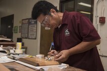 Yutaka Kashiwazaki, a 35th Force Support Squadron woodshop master laborer, adds details to a plaque at the woodshop at Misawa Air Base, Japan, Aug. 1, 2017. Vanessa Breen, the 35th FSS director of arts and crafts and auto complex, considers Kashiwazaki an important asset to the shop because of his talent and skill in woodworking. (U.S. Air Force photo by Airman 1st Class Sadie Colbert)
