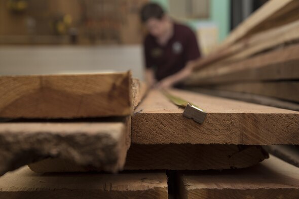 Demi Ebert, a 35th Force Support Squadron recreation assistant, measures cedar planks in the woodshop at Misawa Air Base, Japan, Aug. 1, 2017. The shop carries various types of wood like mahogany, cherry and purpleheart. (U.S. Air Force photo by Airman 1st Class Sadie Colbert)