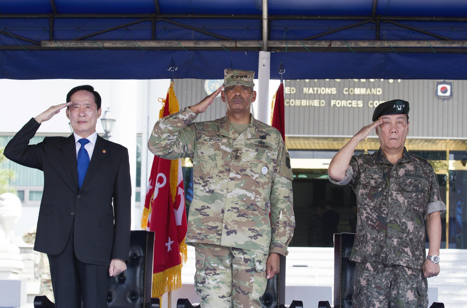From left, Republic of Korea Minister of National Defense Song, Young-moo, General Vincent K. Brooks, commander of United Nations Command, Combined Forces Command and United States Forces Korea, and Gen. Leem Ho-young, deputy commander of CFC, render the appropriate honors during a ceremony at U.S. Army Garrison Yongsan, Republic of Korea, Aug. 4. The visit was the Honorable Song’s first time to USFK headquarters since taking over as the MINDEF July 14. The ceremony included an inspection of the troops, a 19-gun salute and a presentation of one of the shell casings to honor the MINDEF.