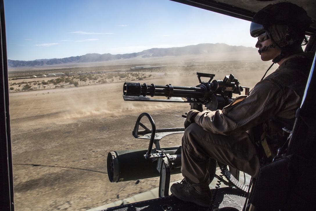 U.S. Marine Corps Staff Sgt. Dustin S. Miller, Crew Chief with Marine Light Attack Helicopter Squadron 167, Marine Air Ground Task Force 8 (MAGTF) searches for a potential target area from a UH-1Y Huey Helicopter before beginning a close air support drill during Integrated Training Exercise (ITX) 5-17 at Marine Corps Air Ground Combat Center, Twentynine Palms, Calif., July 21, 2017. The purpose of ITX is to create a challenging, realistic training environment that produces combat-ready forces capable of operating as an integrated MAGTF. (U.S. Marine Corps Photo by Sgt. Kassie L. McDole)