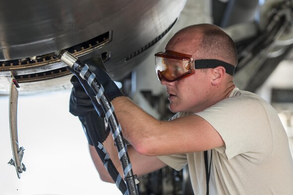 U.S. Air Force Tech. Sgt. Evan Williamson assigned to the 37th Expeditionary Maintenance Squadron, services a B-1B Lancer after it arrived at Andersen AFB, Guam July 26, 2017. The 37th EBS replaces the 9th EBS from Dyess AFB, Texas, which is currently supporting U.S. Pacific Command’s Continuous Bomber Presence mission. (U.S. Air Force photo/ Airman 1st Class Christopher Quail)