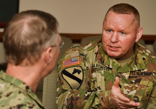 Lt. Col. Chad Blacketer, right, 841st Transportation Battalion commander, briefs Rear Adm. Lawrence Jackson, left, U.S. Transportation Command Strategy, Capabilities, Policy and Logistics Directorate outgoing director, Aug. 1 at the Joint Base Charleston - Weapons Station as part of an orientation visit. Jackson and Rear Adm. Peter Clarke, USTRANSCOM Strategy, Capabilities, Policy and Logistics Directorate incoming director, received a 437th Airlift Wing mission briefing, observed demonstrations and toured a C-17 Globemaster III and the 437th Aerial Port Squadron during the visit. USTRANSCOM is a unified, functional combatant command which provides support to the eight other U.S. combatant commands, the military services, defense agencies and other government organizations by providing full-spectrum global mobility solutions and related enabling capabilities for supported customers’ requirements in peace and war.