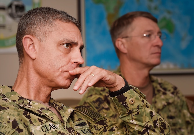 Rear Adm. Peter Clarke, left, U.S. Transportation Command Strategy, Capabilities, Policy and Logistics Directorate incoming director, and Rear Adm. Lawrence Jackson, right, USTRANSCOM Strategy, Capabilities, Policy and Logistics Directorate outgoing director, listen to a mission briefing Aug. 1 presented by soldiers from the 841st Transportation Battalion at the Joint Base Charleston - Weapons Station as part of an orientation visit. Jackson and Clarke received a 437th Airlift Wing mission briefing, observed demonstrations and toured a C-17 Globemaster III and the 437th Aerial Port Squadron during the visit. USTRANSCOM is a unified, functional combatant command which provides support to the eight other U.S. combatant commands, the military services, defense agencies and other government organizations by providing full-spectrum global mobility solutions and related enabling capabilities for supported customers’ requirements in peace and war.